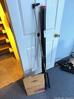 BenQ retail box beside collapsed projection screen on tripod