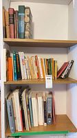 Three wooden shelves filled with books