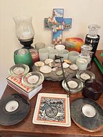 Overall view of candles, holders, decor items on tabletop