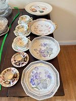 Group shot showing entire lot: platter, serving bowl, plates, multiple teacups and saucers