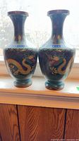 Pair of matching cloisonné vases on windowsill