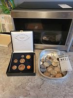 Overview showing Centennial set and tray of loose coins