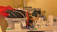 Overview of bin with cords, timers, rope, packaged items