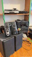 Full lot showing Logitech and AIWA speakers, AIWA stereo stack, DVD player and wiring