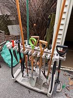 Front view of Suncast cart loaded with various long-handle tools