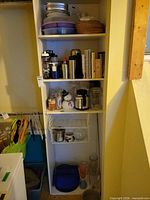 Full shelving unit showing assorted kitchenware