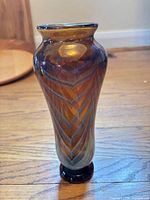 Front view of amber patterned art glass vase