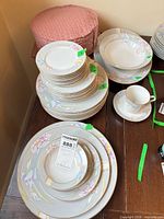Stacked Mikasa Charisma Gray plates of various sizes with teacup, saucer and fabric protectors