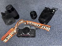Group shot showing camera body, two lenses, two pouches, and Henry’s strap
