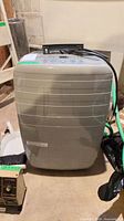 Front view of Noma portable dehumidifier showing full unit and attached hose