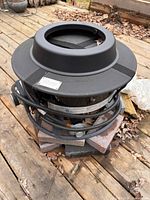 Full view of Outland fire bowl showing hose, regulator, and top ring