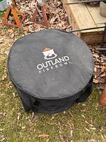 Zippered black fabric carry bag with Outland Firebowl logo