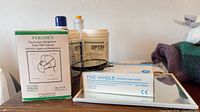 Pyramex N95 mask box, nitrile glove box, Optim wipe canisters, sanitizer bottle, safety goggles visible