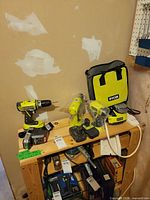 Overview of both drills, chargers, batteries and tool bag on shelf