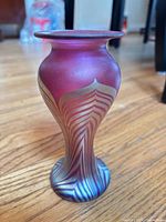 Full view of vase showing shape and iridescent pulled-feather design