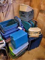 Overall view of stacked assortment of bins, crates and totes