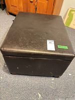 Closed ottoman showing exterior scuffs and size