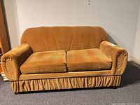 Front view of brown-gold velveteen loveseat with two seat cushions