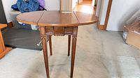 Full view of drop-leaf table with leaves raised