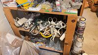 First shelving unit with cords and tools on shelves