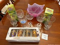 Overview of all glassware including Harry Potter box, Rainforest Cafe boxes, wine glasses and pink bowl