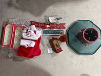 all items laid out including stockings, ornaments, tree stand, signs, gravy boat, cup, lantern