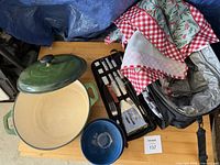 Overview of Dutch oven, lid, utensil tray, bowl, napkins, picnic bag