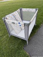 Graco Pack 'n Play playard with two foldable patterned mattresses inside