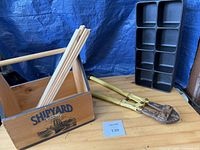 Bolt cutters, wooden Shipyard tote with paint sticks, black organizer tray