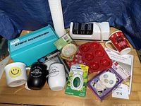 Overview of all items including knife sharpener, mugs, tumblers, silicone mold, cupcake liners, phone case, fragrance warmer