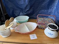 All items grouped on tabletop: divided casserole, mixing bowls, milk-glass containers with spoons, sewing basket, percolator