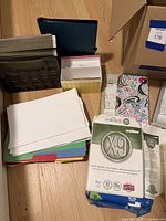 Overall group showing copy paper ream, notebooks, folders, crate