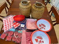 Lot overview showing two straw lanterns, bowls, basket, napkins, lids and treat bags