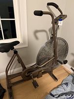 Side view of Schwinn fan bike showing frame, fan wheel, pedals, console, handlebars, seat