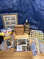 Overview of books, baskets, thread rack, cones, notions, framed print
