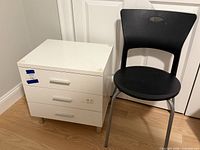 Nightstand closed beside chair, front view