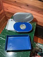 Closed presentation case and outer box with coin inside