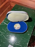 Coin in open presentation case showing overall packaging