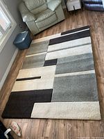 Full view of rug showing entire geometric pattern and colors