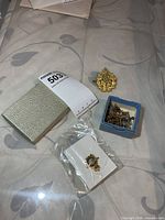 Overall lot view showing boxes, RAF badge, additional gilt badge and box of small pins