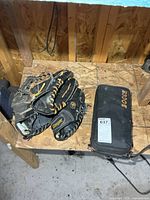 Overview of three gloves stacked and bocce case