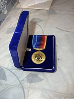 Medal in open blue velvet case
