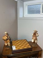 Overall view of chess board and both figures on table