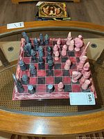Full view of stone chess board with pieces set up