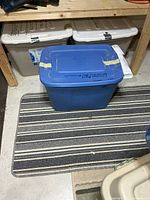 sealed blue tote sitting on striped rug