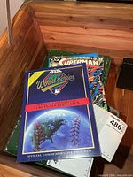 Stack showing 1992 World Series program on top of three Superman comics