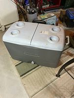 Entire cooler showing double lids with cup holders and pull handle