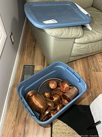 Blue tote containing copper pitcher, cups and tray