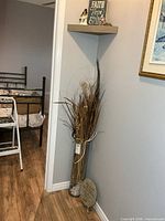 Vase with dried floral, shelf with decor in situ