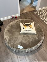 Top view of round dog bed with pillow